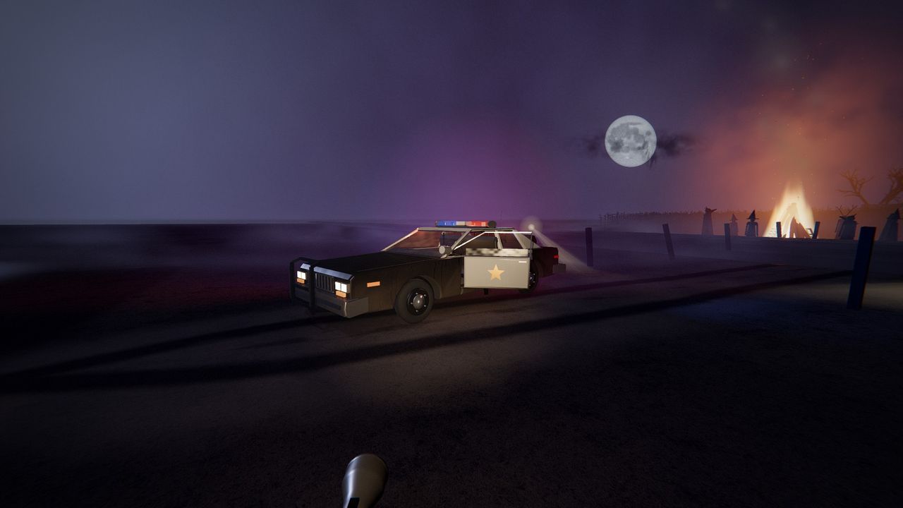 A patrol car with its roof light turning beside a barn at night